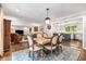 Open-concept dining area with elegant lighting, and table, flowing into the living room and kitchen at 504 Kingswood Nw Ln, Atlanta, GA 30305