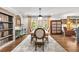 Beautiful dining room featuring hardwood floors, bright light from large window, table for six at 504 Kingswood Nw Ln, Atlanta, GA 30305