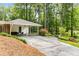 Long driveway leading to a carport with a covered entry, complemented by well-maintained landscaping at 504 Kingswood Nw Ln, Atlanta, GA 30305