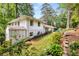 Rear view of home featuring backyard patio, fenced yard, and lush landscaping at 504 Kingswood Nw Ln, Atlanta, GA 30305