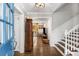 Bright foyer with hardwood floors, staircase, and a view into the living area at 504 Kingswood Nw Ln, Atlanta, GA 30305