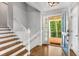 Open foyer with hardwood floors, staircase and a glimpse of the outdoor greenery at 504 Kingswood Nw Ln, Atlanta, GA 30305