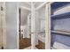 Hallway with laundry storage, powder room and staircase to the upper level at 504 Kingswood Nw Ln, Atlanta, GA 30305