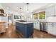 Modern kitchen with stainless steel appliances, a center island, and an open layout into dining area at 504 Kingswood Nw Ln, Atlanta, GA 30305