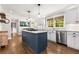 Open kitchen with modern island, stainless appliances, and view to the dining area at 504 Kingswood Nw Ln, Atlanta, GA 30305