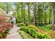Beautifully landscaped yard featuring lush greenery, mature trees, and a stone walkway at 504 Kingswood Nw Ln, Atlanta, GA 30305