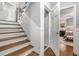 Elegant staircase with hardwood steps and white risers leads to a hallway and bedroom space at 504 Kingswood Nw Ln, Atlanta, GA 30305