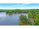 Scenic aerial view of a house nestled by a serene lake surrounded by dense forest at 160 Old Mill Ct, Fayetteville, GA 30214