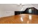 Bright attic with wood floor, custom bookcases, window, and slanted ceilings at 160 Old Mill Ct, Fayetteville, GA 30214