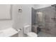 Modern bathroom features a gray tiled shower, glass door, and clean, white fixtures at 160 Old Mill Ct, Fayetteville, GA 30214