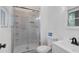 White bathroom features a glass shower with white tile and a modern sink and toilet at 160 Old Mill Ct, Fayetteville, GA 30214