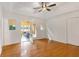Bright bedroom features hardwood floors, ceiling fan, and access to a light-filled sunroom at 160 Old Mill Ct, Fayetteville, GA 30214