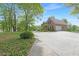 Wide driveway with green grass and lush ivy leading to a brick home with a garage at 160 Old Mill Ct, Fayetteville, GA 30214