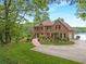 Beautiful brick home with a well-manicured lawn and landscaping at 160 Old Mill Ct, Fayetteville, GA 30214