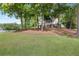 Beautiful multi-story home surrounded by lush trees and a large lawn, offering privacy and a connection to nature at 160 Old Mill Ct, Fayetteville, GA 30214