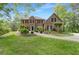 Beautiful brick home with manicured lawn, mature trees, and a brick walkway to the front door at 160 Old Mill Ct, Fayetteville, GA 30214
