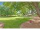 Lush green front lawn with mature trees, offering privacy and natural beauty at 160 Old Mill Ct, Fayetteville, GA 30214