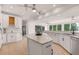 Open-concept kitchen with granite countertops, stainless appliances, and white cabinetry at 160 Old Mill Ct, Fayetteville, GA 30214