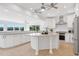 Lovely kitchen featuring granite counters, stainless appliances, an island, and a view of the lake at 160 Old Mill Ct, Fayetteville, GA 30214