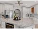 Close up shot of the kitchen island with granite countertops and stainless appliances at 160 Old Mill Ct, Fayetteville, GA 30214