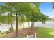 A relaxing view of the lake, the lawn and mature trees at 160 Old Mill Ct, Fayetteville, GA 30214
