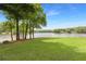 View of the lake from a beautifully maintained lawn and lush mature trees at 160 Old Mill Ct, Fayetteville, GA 30214