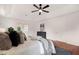 Comfortable bedroom featuring a tray ceiling, hardwood floors, and a cozy gray rug at 160 Old Mill Ct, Fayetteville, GA 30214