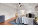 Inviting bedroom boasts hardwood floors, tray ceiling, and comfortable bedroom furnishings and ensuite bathroom at 160 Old Mill Ct, Fayetteville, GA 30214