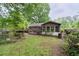 Private backyard with a small deck or patio area and beautiful trees, creating a serene outdoor retreat at 1690 Cedar Grove Dr, Marietta, GA 30066