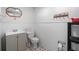 Cozy bathroom with tiled walls, a vanity, toilet and small decorative shelves; practical and clean at 1690 Cedar Grove Dr, Marietta, GA 30066