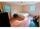 Cozy bedroom with ceiling fan, hardwood floors, and two windows that fill the room with natural light at 1690 Cedar Grove Dr, Marietta, GA 30066