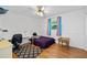 Cozy bedroom with wood floors, ceiling fan, desk, and a geometric area rug at 1690 Cedar Grove Dr, Marietta, GA 30066