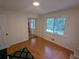 Well-lit bedroom with wood floors and mirrored closet doors at 1690 Cedar Grove Dr, Marietta, GA 30066