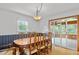 Dining room with table, chandelier, hardwood floors, and view to sun room at 1690 Cedar Grove Dr, Marietta, GA 30066
