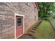 Basement walkout, brick exterior with steps leading to a fenced yard, offering backyard access at 1690 Cedar Grove Dr, Marietta, GA 30066
