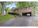 Brick home featuring an attached garage and well-maintained grounds, offering both convenience and classic style at 1690 Cedar Grove Dr, Marietta, GA 30066