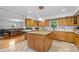 Bright kitchen features an island with granite countertop, custom wood cabinetry, and modern appliances at 1690 Cedar Grove Dr, Marietta, GA 30066