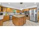 Bright kitchen featuring stainless steel appliances, tile flooring, and center island at 1690 Cedar Grove Dr, Marietta, GA 30066