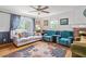 Bright living room with hardwood floors, ceiling fan, large window and sofa at 1690 Cedar Grove Dr, Marietta, GA 30066