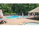 Community pool area with ample lounge chairs, umbrellas, and well-maintained decking, offering a resort-style experience at 1690 Cedar Grove Dr, Marietta, GA 30066