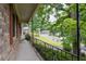 Inviting covered porch with wrought iron railing offering a peaceful view of the neighborhood at 1690 Cedar Grove Dr, Marietta, GA 30066