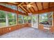 Cozy sun room featuring wood-paneled walls, tile flooring, and natural light at 1690 Cedar Grove Dr, Marietta, GA 30066