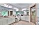 A spacious bathroom with a dual sink vanity, a makeup area, and a glass enclosed shower with tan tiling at 2043 Mason Mill Rd, Decatur, GA 30033