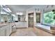 A large bathroom featuring double vanities, a soaking tub and a shower with tile surround and glass door at 2043 Mason Mill Rd, Decatur, GA 30033