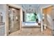 This bathroom features a shower with a glass door and a tub beneath a window with a view of the trees at 2043 Mason Mill Rd, Decatur, GA 30033