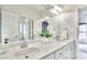 Bright bathroom featuring double sinks, white countertops, and a large mirror at 2043 Mason Mill Rd, Decatur, GA 30033