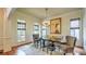 Open dining room with a large table, cushioned bench, windows, and a stylish chandelier at 2043 Mason Mill Rd, Decatur, GA 30033