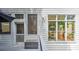 Exterior of home showing white siding, multiple windows and door with access to an outdoor seating area at 2043 Mason Mill Rd, Decatur, GA 30033