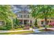 Attractive brick home with a covered front porch, manicured lawn, and mature landscaping at 2043 Mason Mill Rd, Decatur, GA 30033