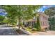 Brick house featuring a covered front porch, well-maintained landscaping, and an inviting curb appeal at 2043 Mason Mill Rd, Decatur, GA 30033